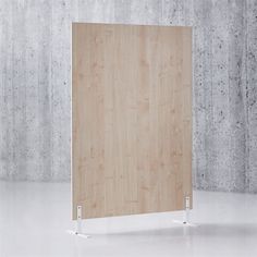 an empty wooden panel with metal legs in front of a concrete wall and white floor