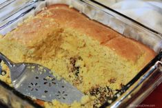 a casserole in a glass dish with a spatula on the side and a piece of bread