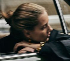 a woman leaning out the window of a car