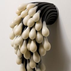 a bunch of black and white objects hanging on a wall