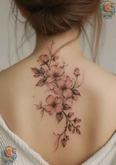 the back of a woman's neck with pink flowers on her left shoulder and chest