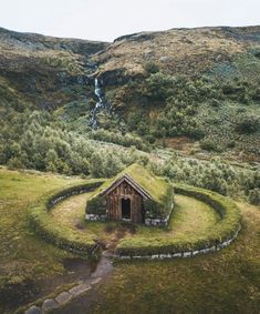 an aerial view of a small hut with grass roof and steps leading up to it