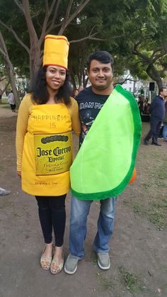 a man and woman dressed in costumes standing next to each other