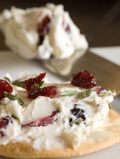 a small pastry with cream and berries on it