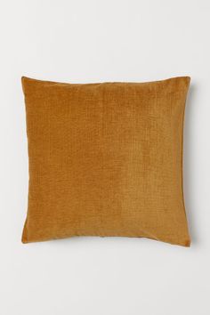 a brown pillow on a white background