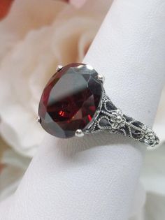 Garnet CZ Ring/ Solid Sterling Silver/ 3ct Oval Cut Garnet | Etsy Oval Garnet Jewelry With Intricate Design, Exquisite Oval Ruby Ring For Wedding, Exquisite Oval Ruby Wedding Ring, Red Ruby Ring With Intricate Design, Ruby Ring With Intricate Design For Wedding, Oval Garnet Filigree Jewelry, Round Red Ruby Ring With Filigree Details, Ornate Round Red Ruby Ring, Ornate Red Ruby Ring For Wedding