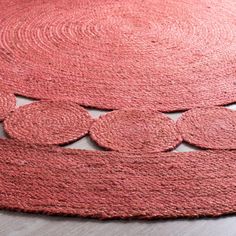 a red rug with circles on the floor