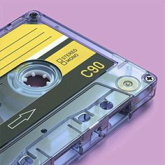 an old fashioned cassette player with its mouth open on a purple background and yellow label