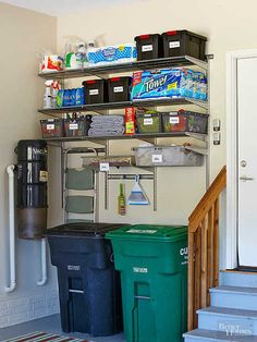 a room with several bins and shelves on the wall