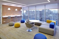 a living room filled with furniture and large windows