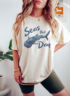 This Comfort Colors whale shark shirt is perfect for your everyday style or your next beach day. The soft-washed, garment-dyed fabric brings extra coziness to your wardrobe, while the relaxed fit makes it an excellent daily choice! 🤩 Tip: THESE RUN TRUE TO SIZE. If you want an oversized look, size up 2-3 sizes. 😉 ✅ Shirt Information: Comfort Colors Unisex Shirt - 100% ring-spun cotton - Medium fabric  - Relaxed fit ✅Design Printing Design printed using Direct to Garment (DTG) print technology. Cotton T-shirt With Shark Design For Summer, Casual Cotton T-shirt With Shark Design, Summer Short Sleeve T-shirt With Shark Design, Casual Short Sleeve Shark Design Tops, Casual Short Sleeve T-shirt With Shark Design, Casual Short Sleeve Top With Shark Design, Casual Summer T-shirt With Shark Design, Summer T-shirt With Shark Design, Short Sleeve, Summer T-shirt With Shark Design And Short Sleeves