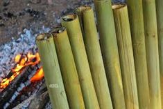 bamboo sticks sitting in front of an open fire