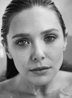 black and white photograph of a woman with freckles on her face looking at the camera