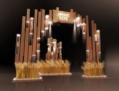 two tall wooden sculptures with grass growing out of them in front of a black background