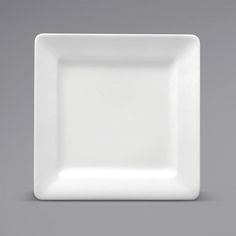 an empty white square plate on a gray background