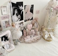 a table topped with lots of dolls and pictures