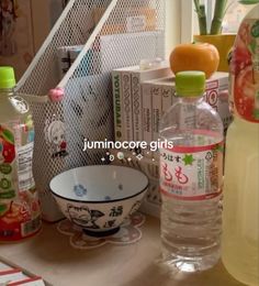 there are many bottles and bowls on the counter top, including one with an orange in it