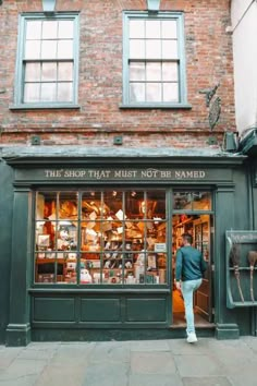 the shop that must not be named is in front of a brick building with lots of windows