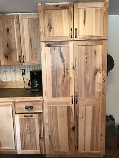 a kitchen with wooden cabinets and black appliances