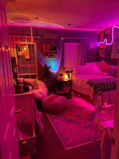 a bedroom with pink lights and rugs on the floor