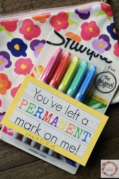 some colorful pens are in a pouch with a note that says you've left a permanent mark on it