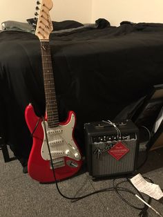 an electric guitar and amp sitting on the floor