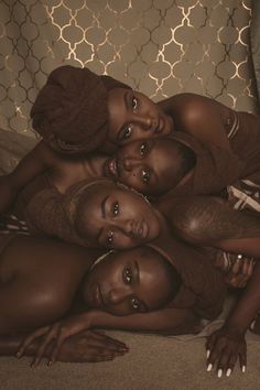 three women are laying down on the floor and one is looking up at the camera