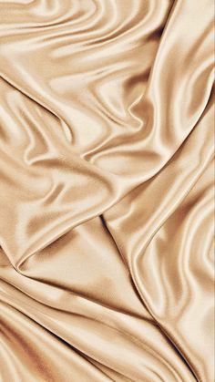 a close up view of a beige silk fabric with very soft, wavy lines and folds