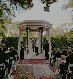 a couple getting married under an outdoor gazebo