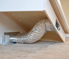 a duct tape wrapped around the side of a cabinet under a bed in a room