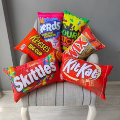 six skittles candy bars are sitting on a chair