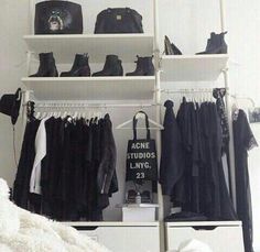 a white closet filled with lots of clothes