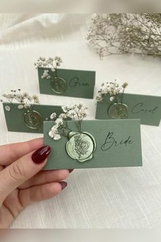 three cards with flowers are held in their hands