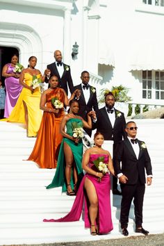 a group of people in formal wear standing on steps