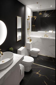 a black and white bathroom with gold accents on the walls, toilet, bidet and sink