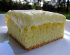 a close up of a piece of cake on a plate with trees in the background