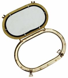 an oval shaped mirror with rivets on the bottom and gold trim around it