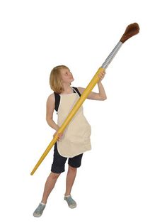 a woman is holding a broom and looking up