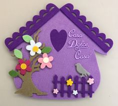 a purple house with flowers and birds on the front is made out of felt that says casa dolce caso