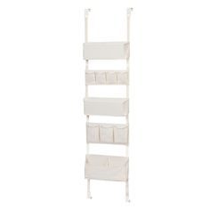 a white shelf with four bins and two shelves on each side, in the shape of a ladder