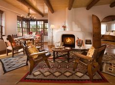 a living room filled with furniture and a fire place in the middle of a room