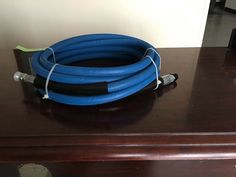 a blue hose sitting on top of a wooden table