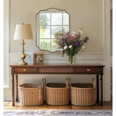 a table with two baskets under a mirror