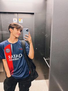 a young man taking a selfie in an elevator