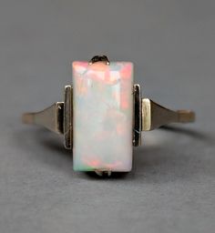 Rare Art Deco 9ct Gold Opal Ring. This wonderful Art deco ring features a rectangular opal of good colour measuring 11mm x 6mm. The opal is a excellent quality solid piece of opal with reds, yellows, blues and greens and displays colour from nearly every angle. The ring is set with claws and angular shoulders of white and yellow gold. the ring has a very classical art deco look and has been inscribed 30/6/1933. The ring is in excellent condition for its age, the shank is strong and the stone has Antique Rings Vintage, Opal Ring Gold, Jewelry Images, Classical Art, Art Deco Ring, Modern Gift, Antique Jewellery, Antique Rings, Opal Rings