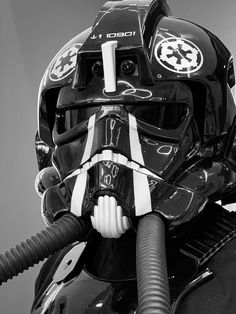 a star wars helmet is attached to the side of a motorcycle with a hose in it's mouth