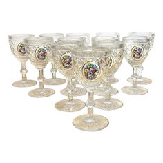 a set of seven glass goblets with designs on them