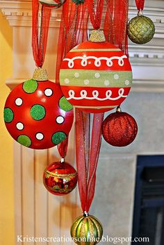 an assortment of christmas ornaments hanging from a mantel