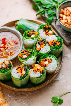 a plate with some food on it next to bowls of beans and sauces,