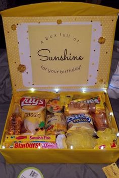 a yellow box filled with snacks and condiments